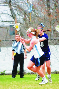 Allie Rock '14, breaking past the defense of a Visitation midfielder. (Photo Courtesy of Lisa Gaisford)