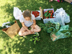 Lucia Andrés spends time at a local farmers’ market, eating fresh organic strawberries.