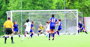 Goalkeeper Maddie Carr, ’16, dives for the ball in a Varsity Soccer game.