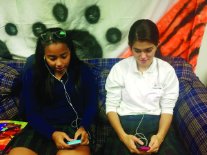 Sydney Rickford, '16 and Ale Orellana, '16 listen to varying types of music in the senior lounge. Photo courtesy of Naima Fonrose